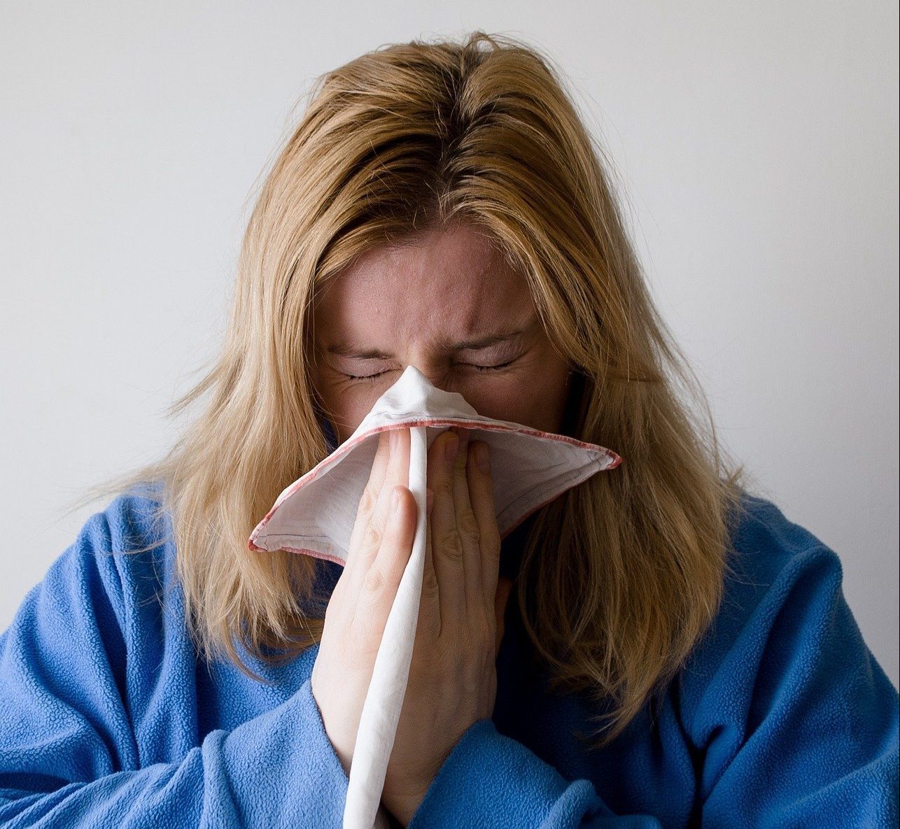 Woman blowing nose